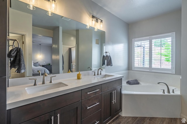 658 N Sage Crest Dr, Washington, UT 84780 - ensuite bathroom featuring visible vents, a sink, wood finished floors, and ensuite bathroom