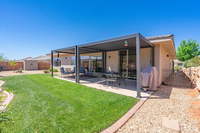 658 N Sage Crest Dr, Washington, UT 84780 - back of house featuring a patio area, a fenced backyard, a storage shed, a lawn, and stucco siding