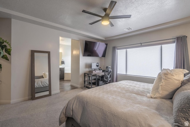 658 N Sage Crest Dr, Washington, UT 84780 - carpeted bedroom with ceiling fan, ensuite bath, visible vents, baseboards, and a textured ceiling