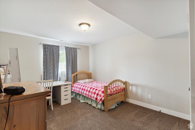 bedroom featuring carpet and baseboards