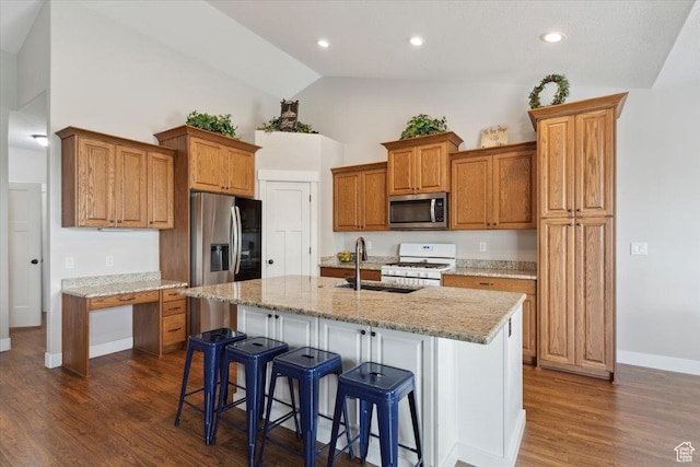 kitchen with a sink, appliances with stainless steel finishes, baseboards, dark wood-type flooring, and high vaulted ceiling
