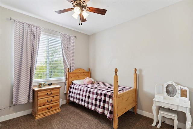 bedroom featuring dark carpet, a ceiling fan, and baseboards