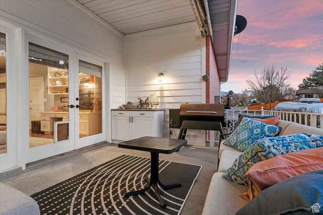 4972 S Boabab Crk, Holladay, UT 84117 - balcony at dusk featuring area for grilling, a patio area, and french doors