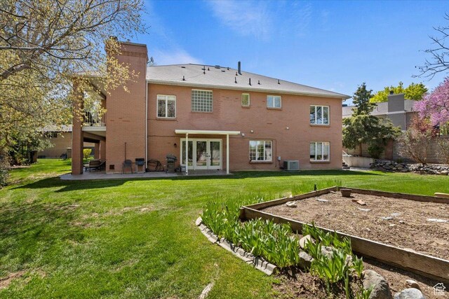 4972 S Boabab Crk, Holladay, UT 84117 - back of property featuring a patio, a yard, french doors, and a chimney
