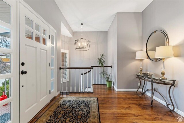 4972 S Boabab Crk, Holladay, UT 84117 - foyer entrance with a notable chandelier, a healthy amount of sunlight, wood finished floors, and baseboards