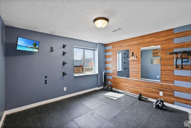 1410 S 4100 W, Syracuse, UT 84075 - exercise area with a textured ceiling, visible vents, wood walls, and baseboards