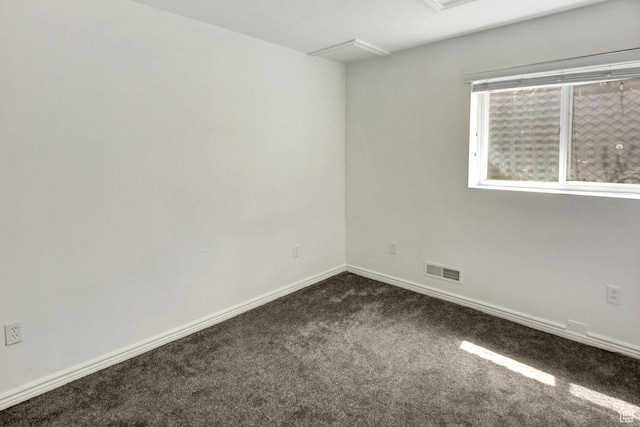 6497 W King Valley Rd, West Valley City, UT 84128 - empty room with baseboards, visible vents, and dark carpet