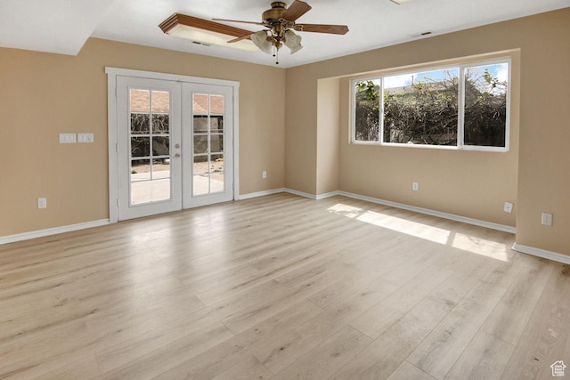 6497 W King Valley Rd, West Valley City, UT 84128 - unfurnished room with light wood-style floors, a ceiling fan, visible vents, baseboards, and french doors