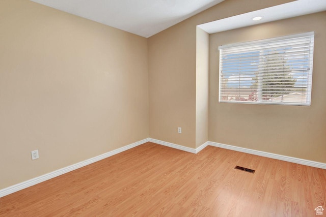6497 W King Valley Rd, West Valley City, UT 84128 - empty room with visible vents, light wood-style flooring, and baseboards