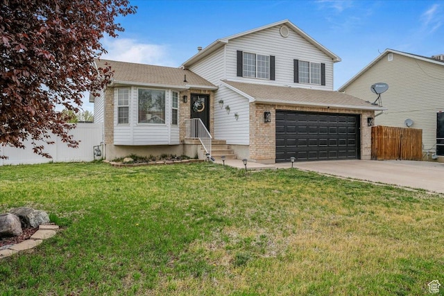4799 S 3950 W, Roy, UT 84067 - split level home with a garage, fence, a front lawn, and concrete driveway