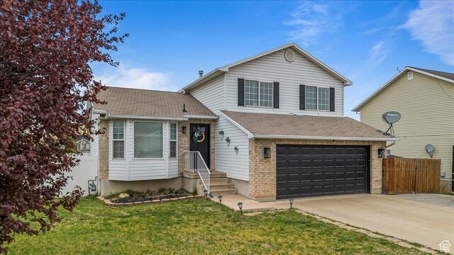 4799 S 3950 W, Roy, UT 84067 - split level home featuring a front lawn, driveway, an attached garage, and fence