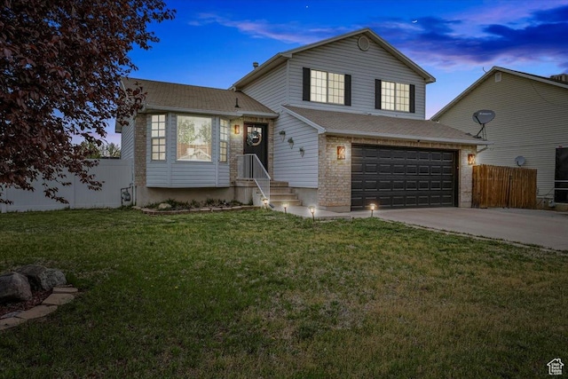 4799 S 3950 W, Roy, UT 84067 - tri-level home with a shingled roof, a lawn, driveway, an attached garage, and fence
