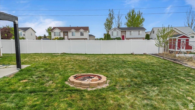 4799 S 3950 W, Roy, UT 84067 - view of yard with a residential view, a storage shed, a fire pit, and fence
