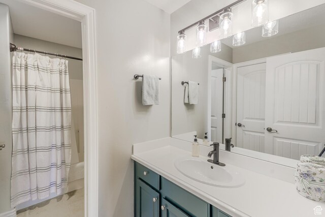 9061 N Clubhouse Ln, Eagle Mountain, UT 84005 - bathroom featuring tile patterned floors, shower / tub combo with curtain, and vanity