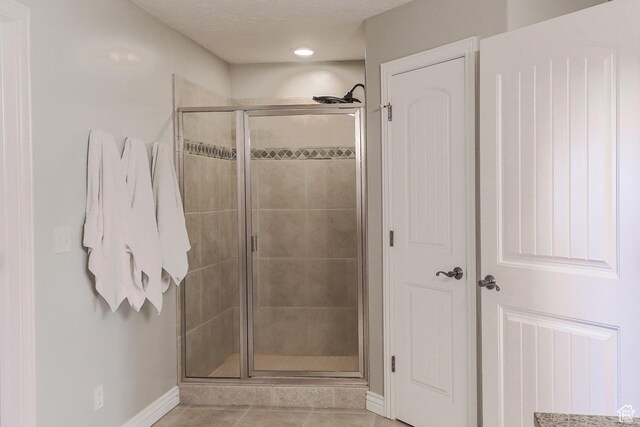 9061 N Clubhouse Ln, Eagle Mountain, UT 84005 - full bathroom featuring baseboards, recessed lighting, a shower stall, and tile patterned flooring