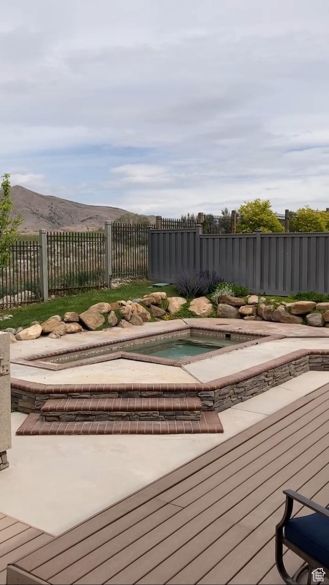 9061 N Clubhouse Ln, Eagle Mountain, UT 84005 - deck featuring a jacuzzi, fence, and a mountain view