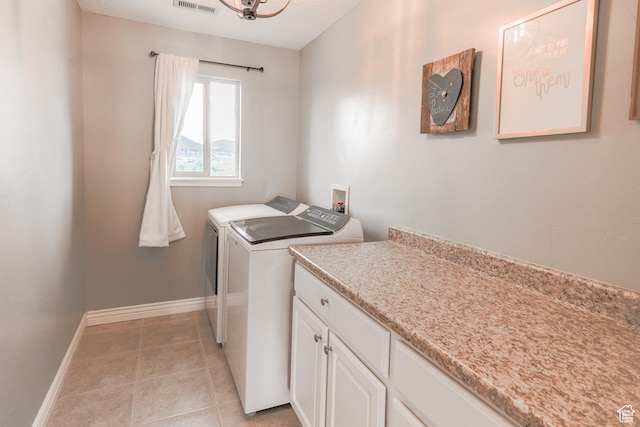 9061 N Clubhouse Ln, Eagle Mountain, UT 84005 - washroom featuring light tile patterned floors, cabinet space, washing machine and clothes dryer, baseboards, and visible vents