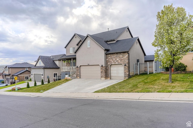 view of front of home with a front lawn, stucco siding, concrete driveway, and stone siding