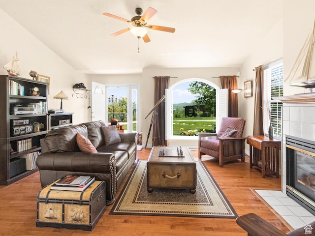 3677 N Willowbrook Ln, Eden, UT 84310 - living area with a fireplace, wood finished floors, a healthy amount of sunlight, and a ceiling fan