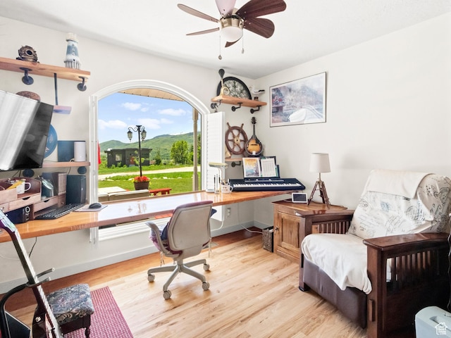 3677 N Willowbrook Ln, Eden, UT 84310 - office area featuring light wood finished floors, a ceiling fan, and baseboards