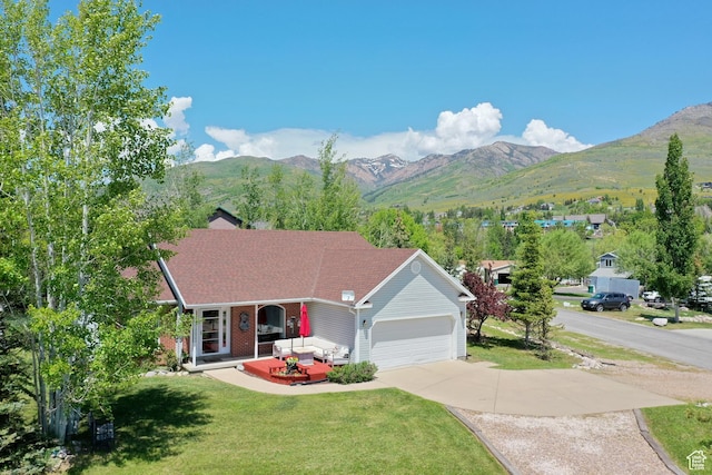3677 N Willowbrook Ln, Eden, UT 84310 - single story home with a front lawn, covered porch, a mountain view, driveway, and an attached garage