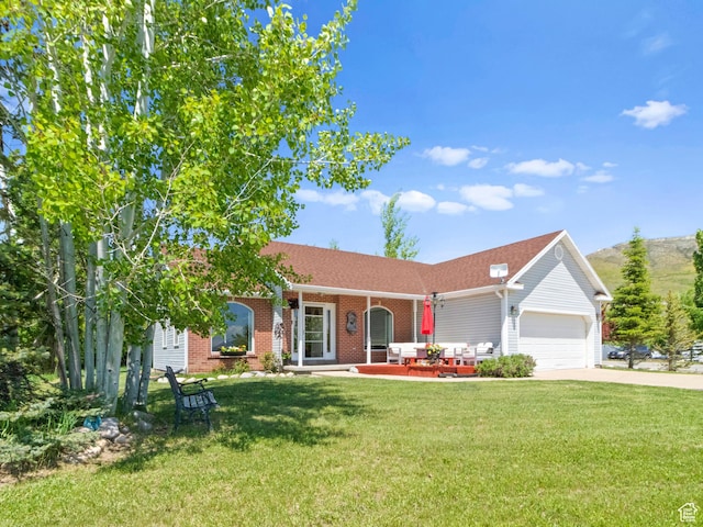 3677 N Willowbrook Ln, Eden, UT 84310 - ranch-style home featuring covered porch, brick siding, driveway, a front lawn, and an attached garage