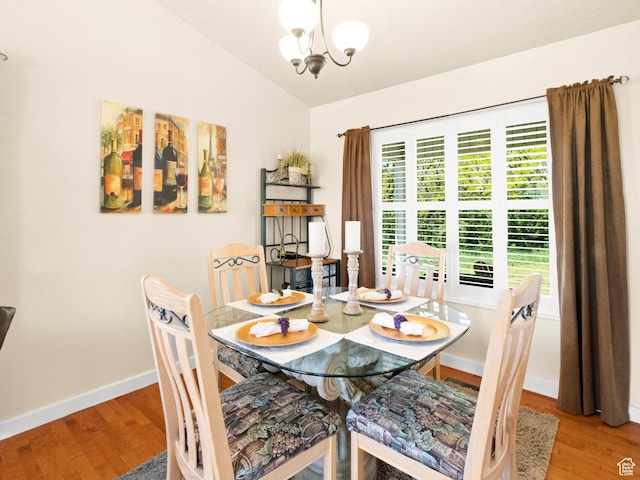3677 N Willowbrook Ln, Eden, UT 84310 - dining space with lofted ceiling, wood finished floors, a notable chandelier, and baseboards