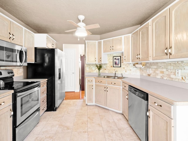 3677 N Willowbrook Ln, Eden, UT 84310 - kitchen with stainless steel appliances, a ceiling fan, and light brown cabinets