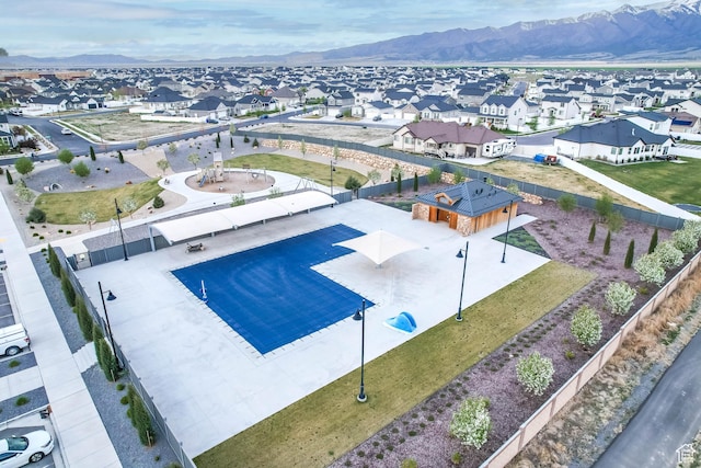 birds eye view of property with a mountain view and a residential view