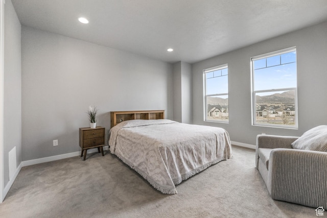 bedroom with baseboards, recessed lighting, and light carpet