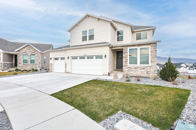 view of front of home featuring board and batten siding, a garage, stone siding, a front lawn, and concrete driveway
