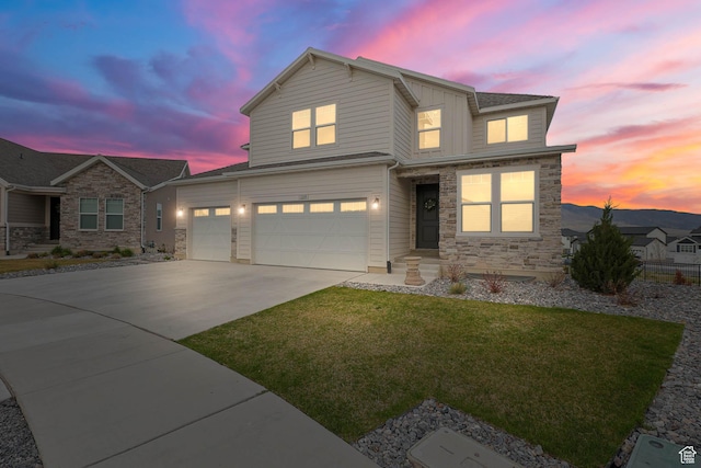 1368 E Clipper Peaks N, Eagle Mountain, UT 84005 - view of front facade with driveway, stone siding, a front lawn, and an attached garage