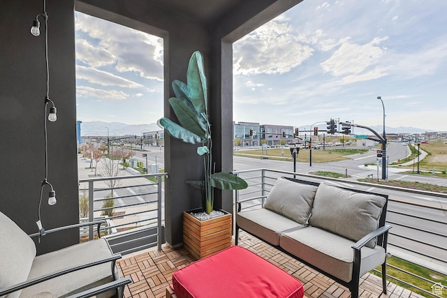 balcony featuring a mountain view and an outdoor living space