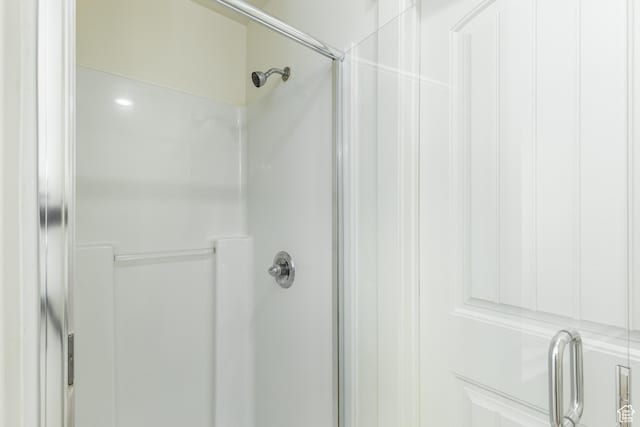 bathroom with a shower with shower door