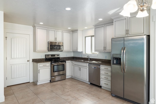 kitchen featuring recessed lighting, pendant lighting, appliances with stainless steel finishes, and a sink