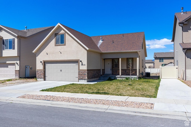 view of front of home with stucco siding, a garage, stone siding, a front lawn, and concrete driveway