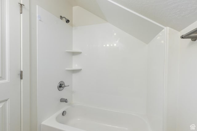 bathroom with bathing tub / shower combination
