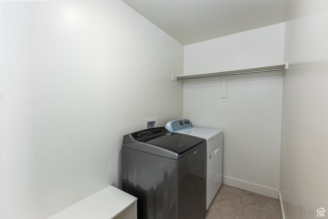 laundry area with washer and dryer, laundry area, and baseboards