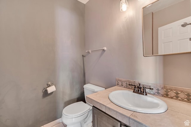 bathroom with toilet and vanity