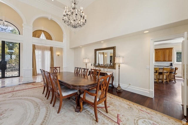 1714 Ridge Point Dr, Bountiful, UT 84010 - dining area with a high ceiling, a notable chandelier, wood finished floors, and baseboards