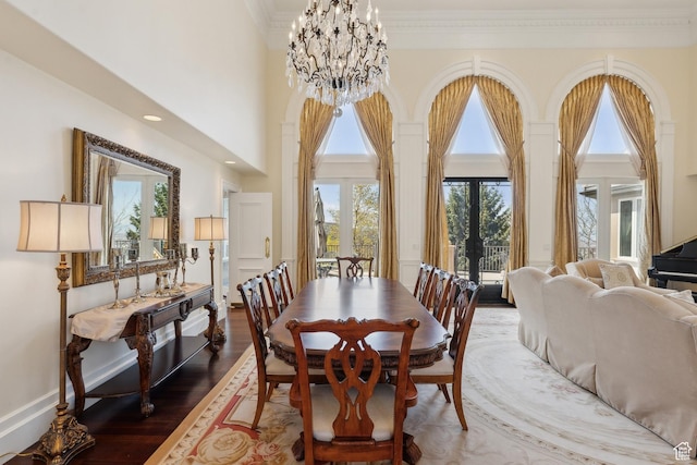 1714 Ridge Point Dr, Bountiful, UT 84010 - dining room featuring ornamental molding, a high ceiling, a notable chandelier, and wood finished floors