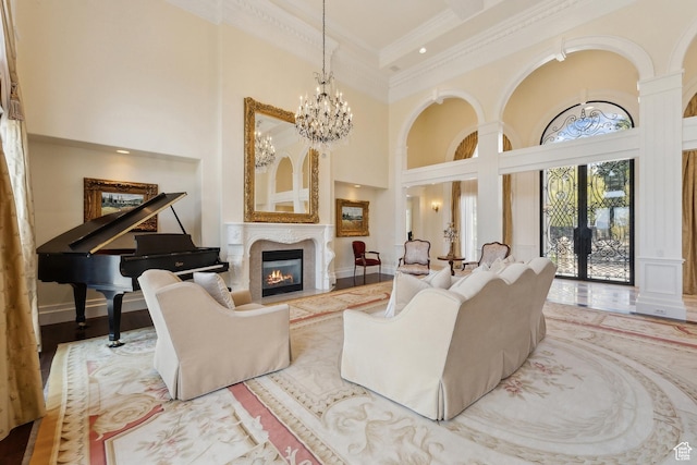 1714 Ridge Point Dr, Bountiful, UT 84010 - living room with an inviting chandelier, a towering ceiling, a glass covered fireplace, and crown molding