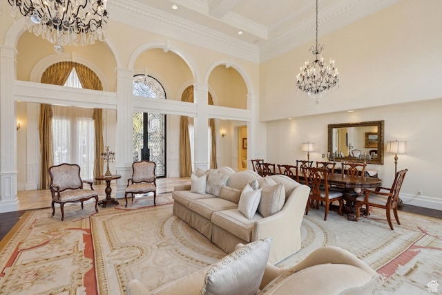 1714 Ridge Point Dr, Bountiful, UT 84010 - living area with a high ceiling, a chandelier, decorative columns, crown molding, and wood finished floors