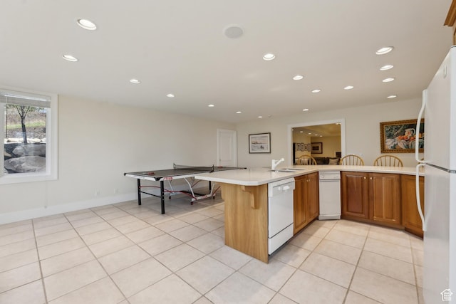 1714 Ridge Point Dr, Bountiful, UT 84010 - kitchen featuring recessed lighting, white appliances, light countertops, and a sink
