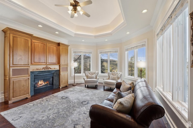 1714 Ridge Point Dr, Bountiful, UT 84010 - living room featuring ceiling fan, a raised ceiling, a glass covered fireplace, ornamental molding, and dark wood finished floors