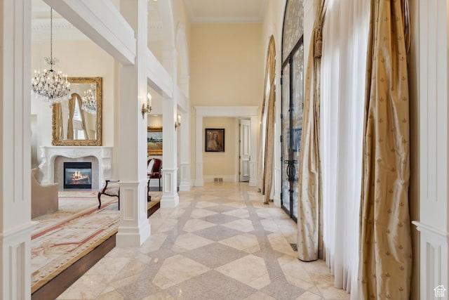1714 Ridge Point Dr, Bountiful, UT 84010 - hallway with crown molding, a towering ceiling, and an inviting chandelier