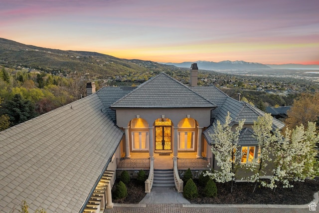 1714 Ridge Point Dr, Bountiful, UT 84010 - view of front of property featuring stucco siding, a chimney, stairs, and a mountain view
