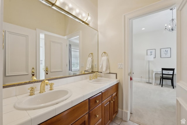 1714 Ridge Point Dr, Bountiful, UT 84010 - bathroom featuring double vanity, an inviting chandelier, baseboards, and a sink