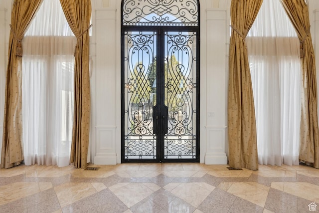 1714 Ridge Point Dr, Bountiful, UT 84010 - interior space featuring a decorative wall, tile patterned flooring, wainscoting, and french doors