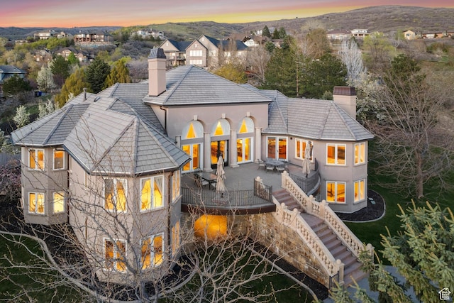 1714 Ridge Point Dr, Bountiful, UT 84010 - rear view of property featuring stucco siding, a chimney, stairs, and a patio